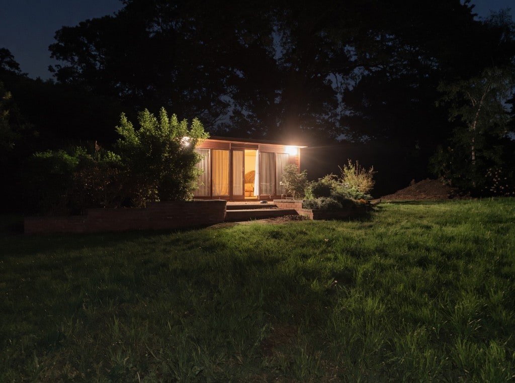 Harry’s garden cabin at night, lit up for the after party